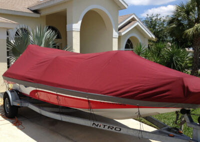 boat with custom red canvas cover