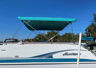 boat with custom teal canopy bimini top