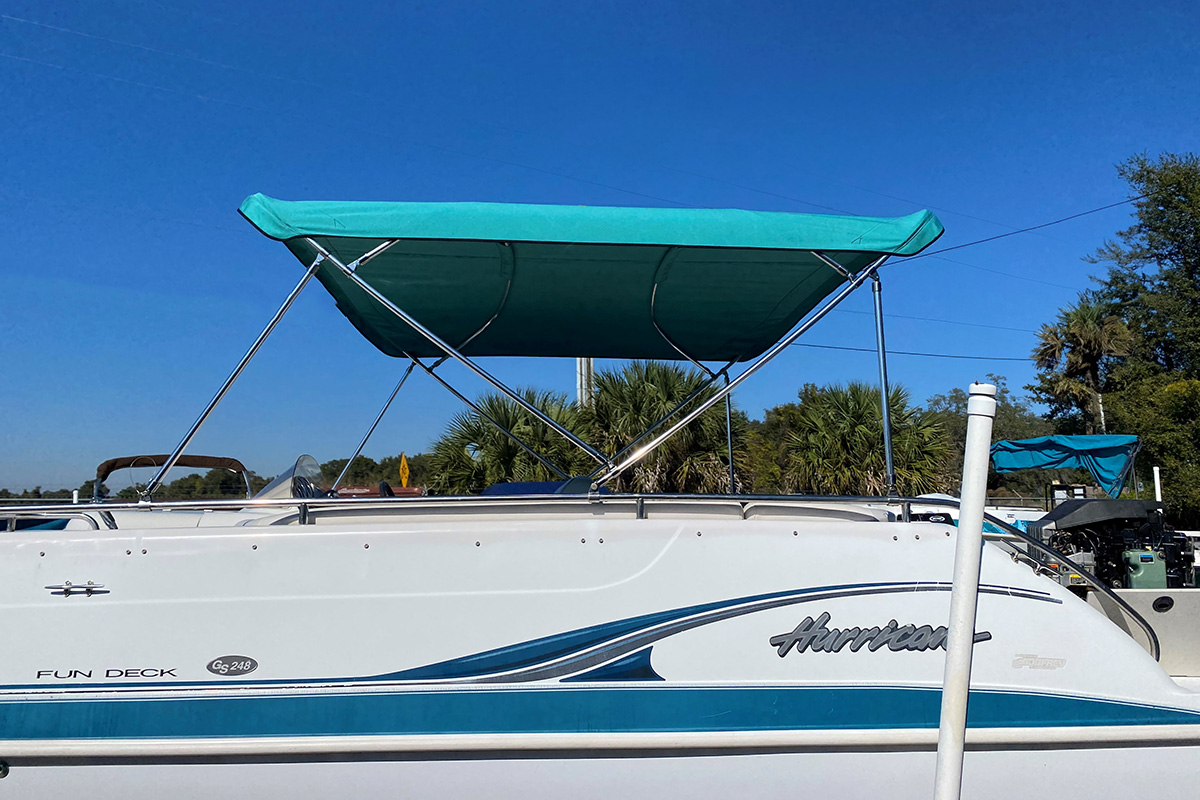 boat with custom teal canopy bimini top