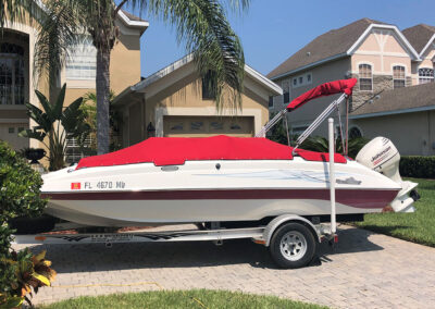 small boat with custom red canvas cover